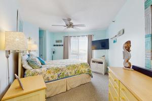 a bedroom with a bed and a ceiling fan at OIB88 PierSide Paradise in Ocean Isle Beach