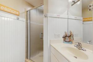 a bathroom with a sink and a shower at OIB88 PierSide Paradise in Ocean Isle Beach +13 photos