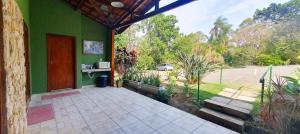 an outside view of a house with a door and a porch at Della Vegas Economy in Serra Negra