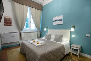 a blue bedroom with a bed with a tray of food on it at Residenza Centro Storico in Lucca