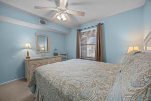 a bedroom with a bed and a ceiling fan at OIB90 Endless Summer in Ocean Isle Beach