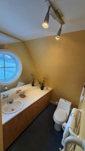 a bathroom with a toilet and a sink at Chalets Multivoile 4 Saisons in Pointe-du-Lac
