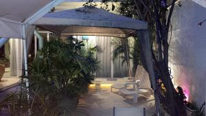 a gazebo with a chair and some plants at fascinating loft with swimming pool in Oaxaca City