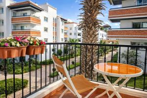 a balcony with a table and chairs and some buildings at Marina Executive Suites in Agadir