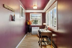 a home office with a desk and a window at State St Parlor Walk Downtown Newly Designed in Portsmouth