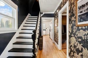 a staircase in a home with black walls at State St Parlor Walk Downtown Newly Designed in Portsmouth