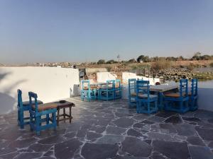 a group of blue chairs and tables on a patio at Mostafa Gest House in Asyut