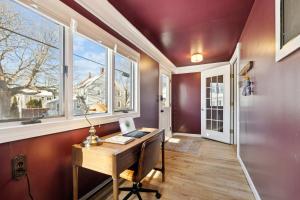 a home office with a desk and windows at State St Parlor Walk Downtown Newly Designed in Portsmouth +48 photos