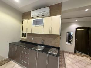 a kitchen with a sink and a sink at شاليهات وشقق ليالي رهيف in Abha