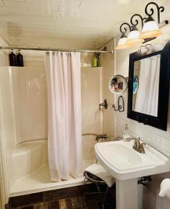 a bathroom with a sink and a tub and a shower at Magnolia Petal Accommodation in Salt Spring Island