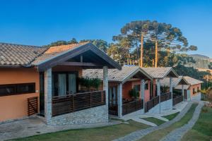 a row of houses with trees in the background at Casa Brandão Pousada in Bueno Brandão