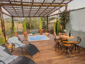 a patio with a table and chairs and a swimming pool at Casa Brandão Pousada in Bueno Brandão