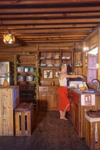 a woman standing at a counter in a kitchen at Casa Bambucha Hostel in Las Peñitas +39 photos