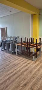 a group of tables and chairs in a room at turistická ubytovňa LIENKA in Holíč