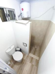 a small bathroom with a toilet and a sink at Luz del Alba in Durazno