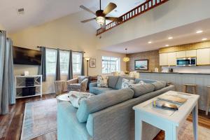 a living room with a couch and a table at SB25A Clubhouse Villa 2BR in Sunset Beach