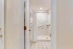 a white bathroom with a shower and a tub at SB25A Clubhouse Villa 2BR in Sunset Beach +20 photos