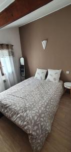 a bedroom with a large bed with pillows at maisonnette bord de mer in Royan