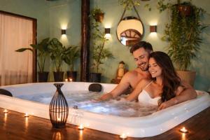a man and a woman sitting in a hot tub at Pousada Pura vida in Itacaré +89 photos