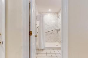 a white bathroom with a shower and a tub at SB25 Clubhouse Villa 3BR in Sunset Beach +32 photos