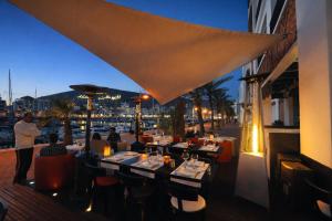 a restaurant with a view of a harbor at night at Marina Executive Suites in Agadir
