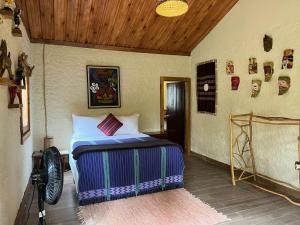 a bedroom with a bed and a wooden ceiling at Pine Ridge Lodge Belize in San Ignacio +28 photos
