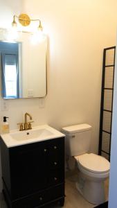 a bathroom with a sink and a toilet and a mirror at Peace Barn Getaway in Carrollton +5 photos