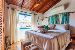 a bedroom with a bed and a large window at CasinhaPiri in Pirenópolis +121 photos