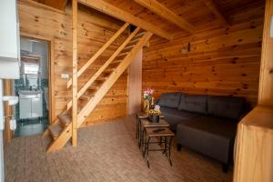 a living room with a staircase in a log cabin at Hotel Sjever in Šavnik