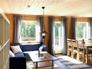 a living room with a blue couch and a table at 4 person holiday home in BENGTSFORS in Bengtsfors