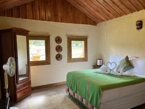 a bedroom with a bed with two white towels at Pine Ridge Lodge Belize in San Ignacio