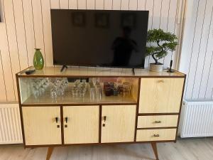 a television on top of a wooden entertainment center at Refugio Austral in Punta Arenas