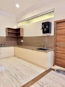 a kitchen with a sink and a counter top at Dar E Noor in Hyderabad