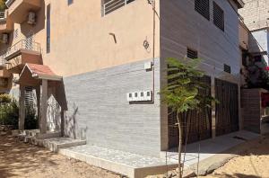 a building with a wall that is painted blue at Camara Homes1 in Saint-Louis