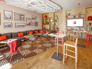 a living room with a couch and tables and chairs at Ibis El Jadida in El Jadida