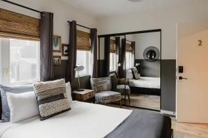 a bedroom with a bed and a room with a mirror at Noon on Sunset Hill in Los Angeles