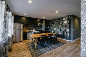 a kitchen with a table and chairs and a refrigerator at Noon on Sunset Hill in Los Angeles