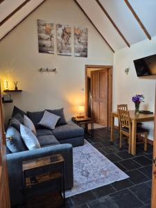 a living room with a couch and a table at The Old Post House in Fort William