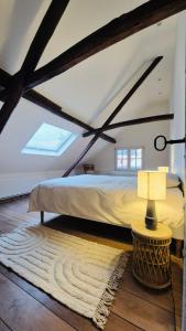 a bedroom with a large bed in a attic at Alcazar in Mechelen