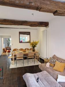 a living room with a table and a dining room at Alcazar in Mechelen