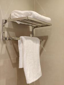 a towel rack in a bathroom with white towels at ذا سهل ستيز in Amman +54 photos