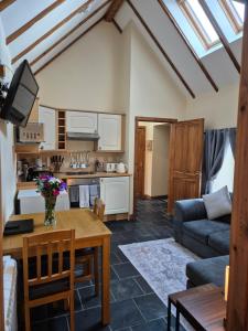 a living room with a couch and a table at The Old Post House in Fort William