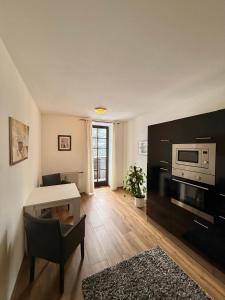 a living room with a table and a microwave at Ferienwohnungen am Luitpold in Berchtesgaden
