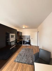 a living room with a couch and a kitchen at Ferienwohnungen am Luitpold in Berchtesgaden