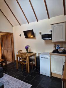 a kitchen with a table and a small table and chairs at The Old Post House in Fort William +12 photos