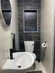 a bathroom with a white toilet and a sink at Black Rose Guesthouse Northam in Northam +13 photos