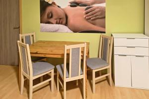 a table and chairs with a picture of a woman sleeping at Relax apartmá Brno central - Brno střed in Brno