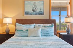 a bedroom with a large bed with two lamps at 8650 - Mare Vista Retreat in Frisco