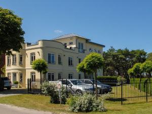 a house with a car parked in front of it at Burg Roland Wohnung 04 in Dierhagen