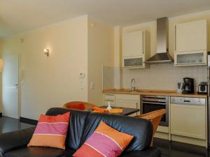 a living room with a couch and a kitchen at Burg Roland Wohnung 04 in Dierhagen +5 photos